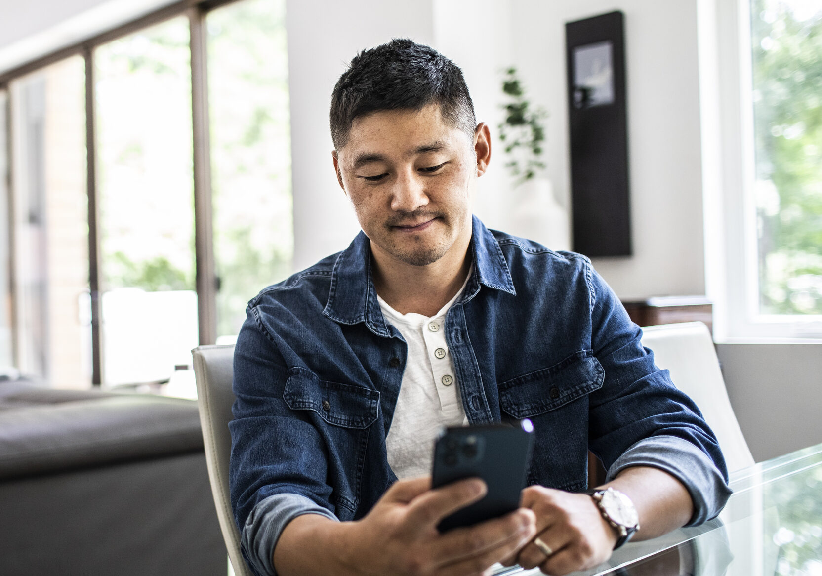 Man using mobile device at home