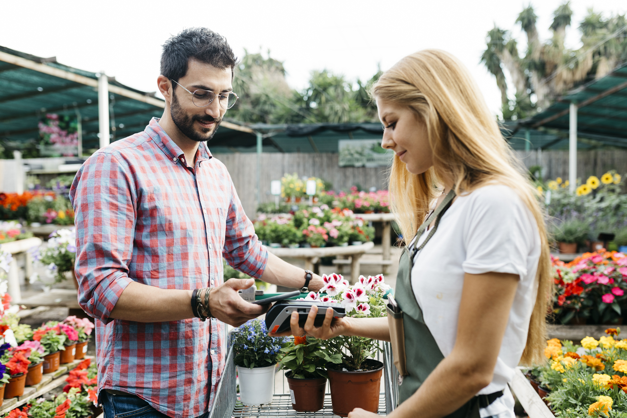 Customer paying with smartphone in a garden center