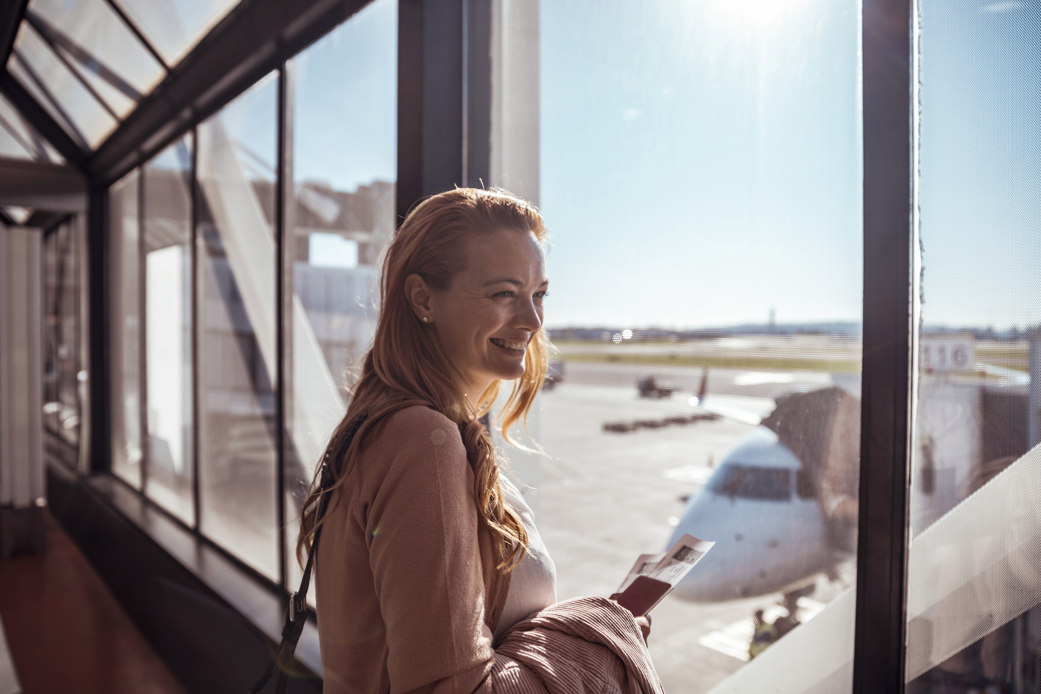 Young woman waiting to board the airplane